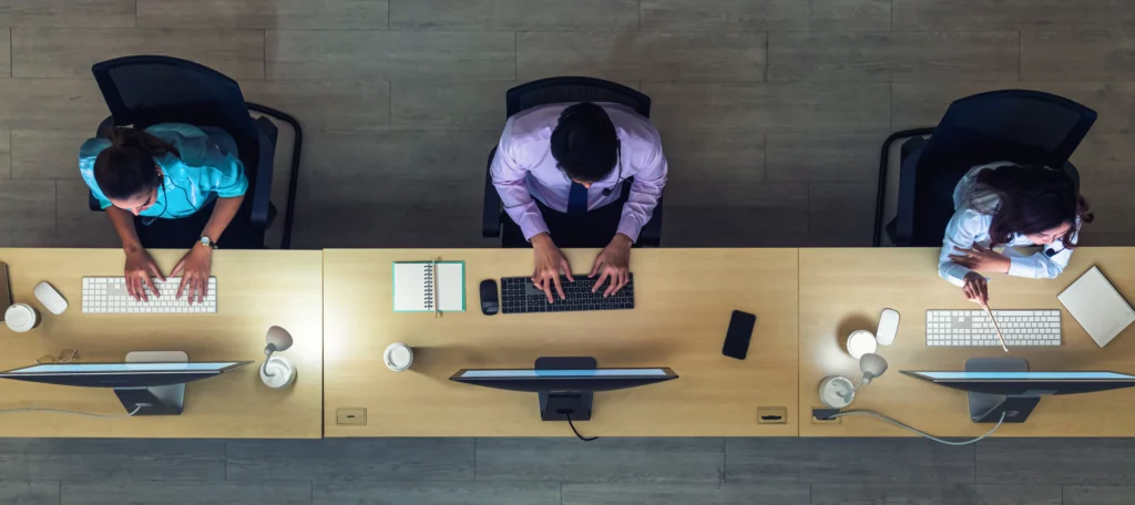 IT support team assisting customers at office desk